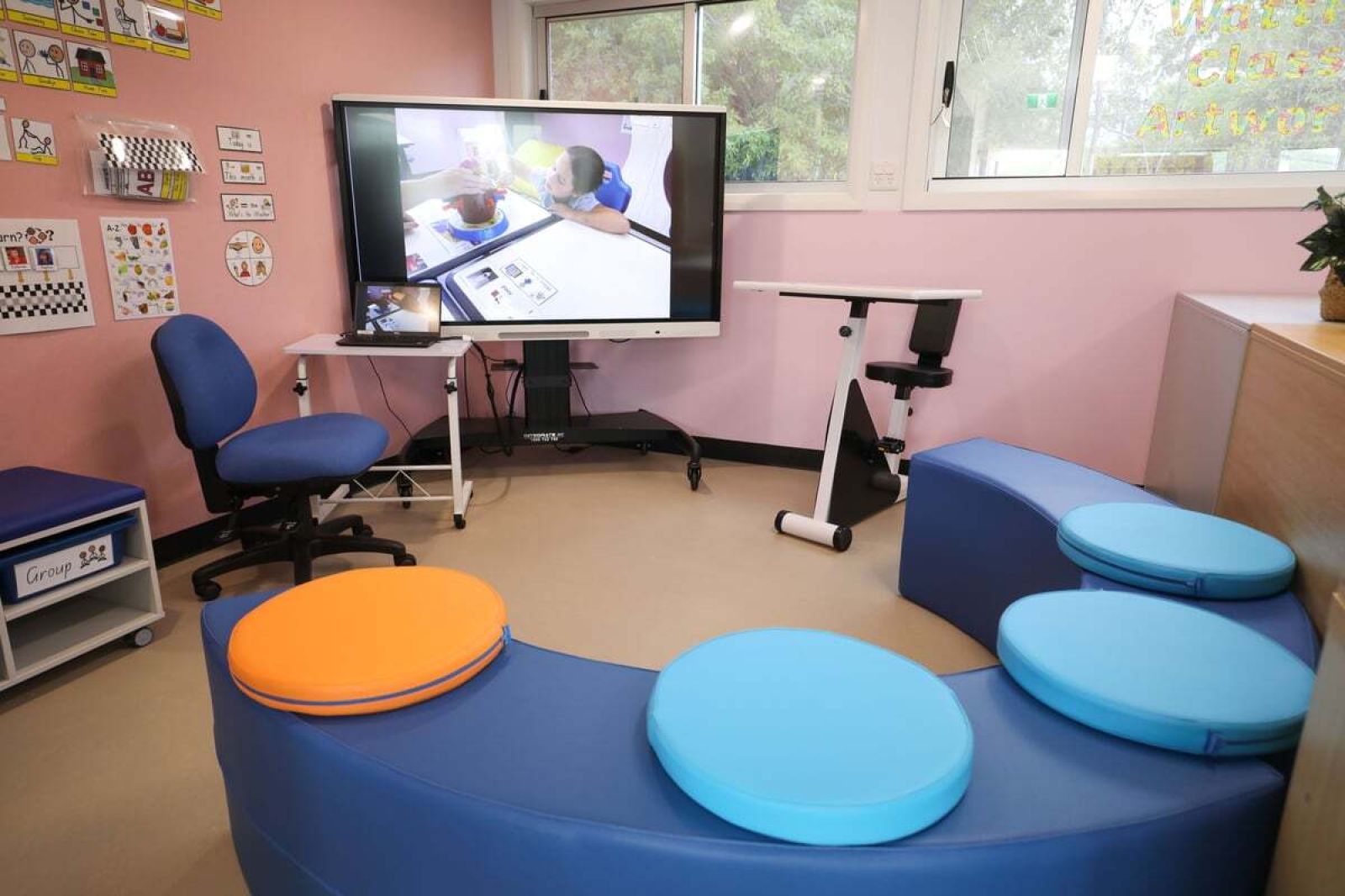 When the students sit down in this section of the classroom, they know it is time for a lesson on the interactive smartboard. Establishing a routine is crucial for children on the autism spectrum.